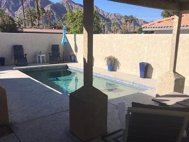 Pool in front of the house. French doors lead out from the kitchen to the pool area.
