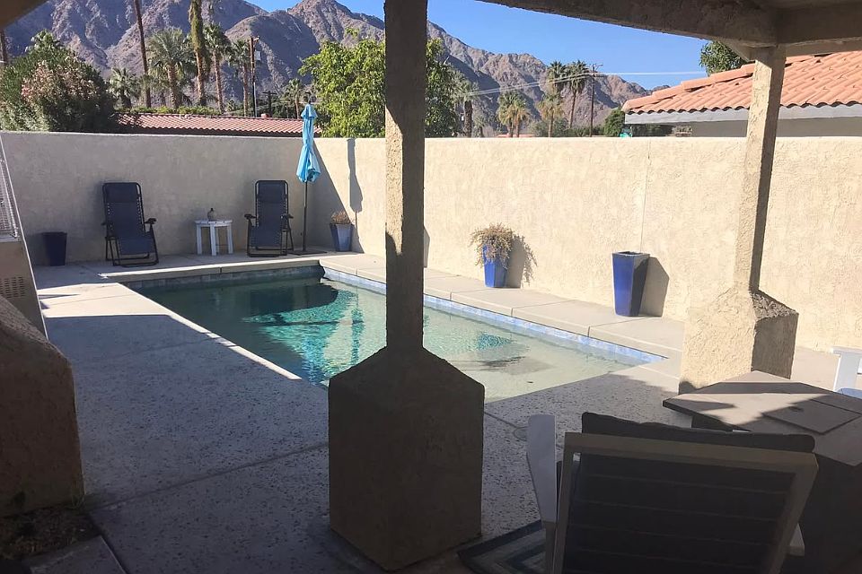 Pool in front of the house. French doors lead out from the kitchen to the pool area.