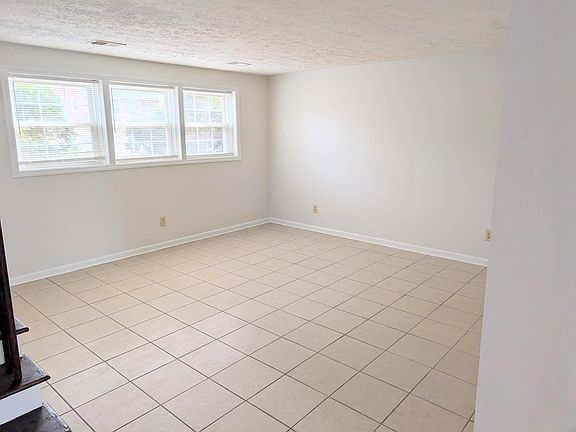 Large bright living room with tiled floor