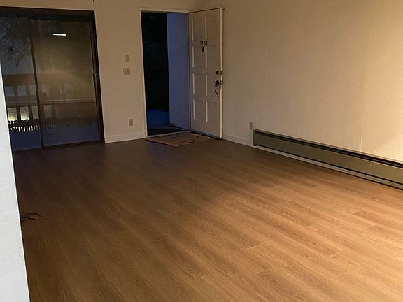 Brand new flooring, a large-sized living room. A sliding door to a balcony.