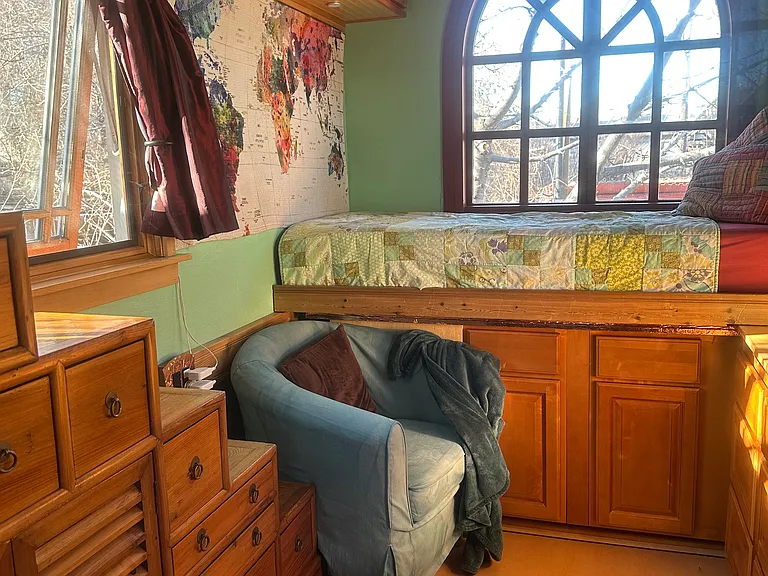 The giant windows open onto the gardens. An apricot tree provides shade and dappled light for the window over the tansu while the cherry tree branches are just outside the arched window.