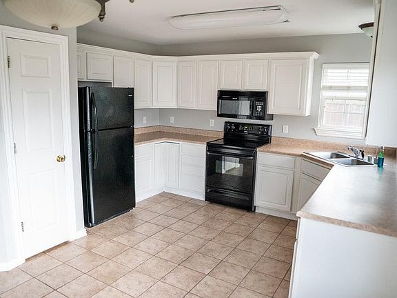 Open kitchen. Lots of natural Light. Light fixtures have been updated since photographed.