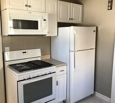 Remodeled kitchen with new stove and microwave.