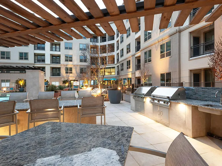 Outdoor Courtyard with Island Bar Seating and Built-In Grilling Stations
