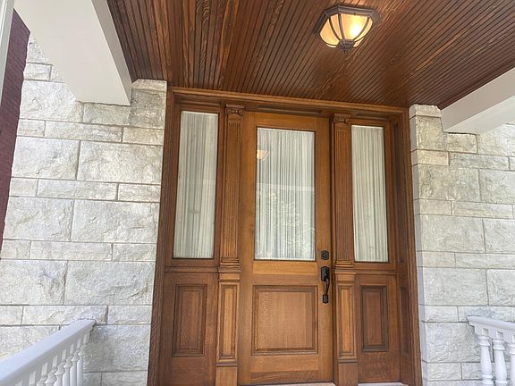 Custom built front door. Some historic elements were preserved but most were recreated to match. Check out the stained bead board ceiling too!