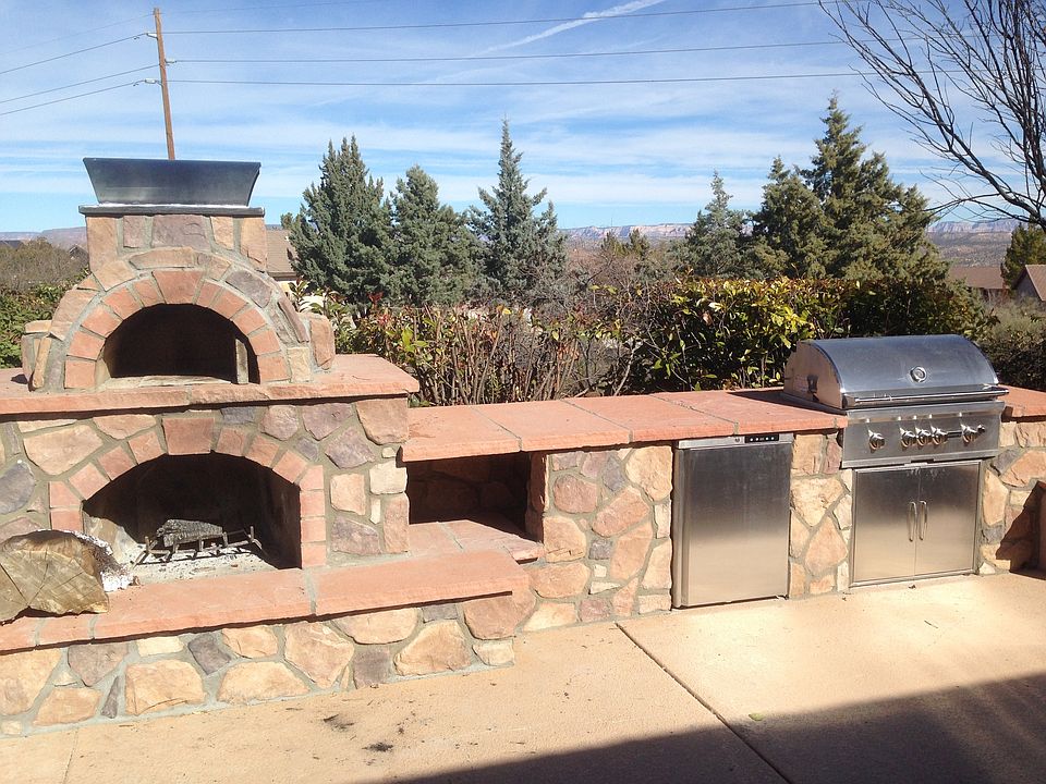Out door kitchen, grill, oven, refrigerator, fireplace.