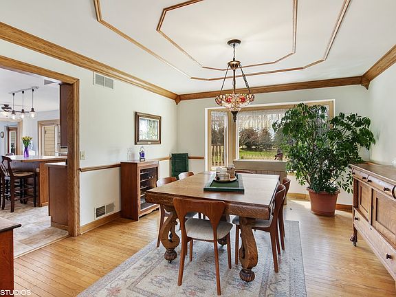 Crown molding, decorative ceiling, hardwood floors, and a bay window offer so much to this beautiful