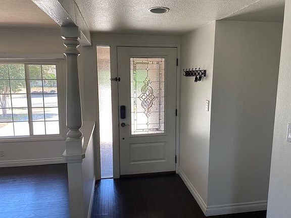 Entryway. Hallway on right leads to all bedrooms and bathrooms. To the left is the living room.