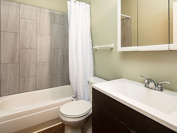 Bathroom freshly updated with tiled tub shower.