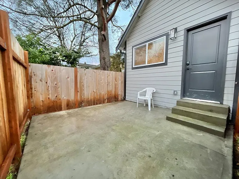 Seamless indoor-outdoor living: Embrace the charm of our back area, accessible via three elegant steps.