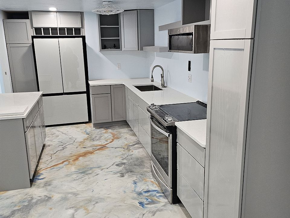 Kitchen see the (2 ) pantry/utility cabinets .
One to left of Bespoke glass front refrigerator the second at end of counter.