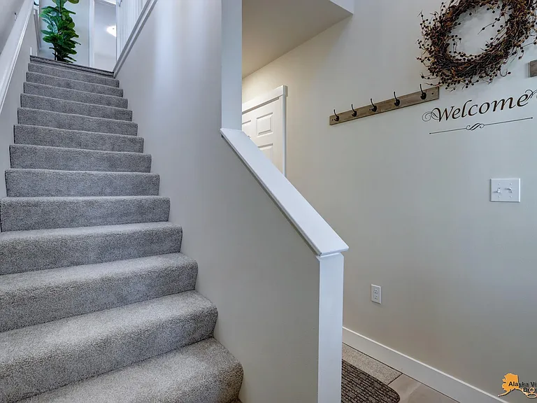 Steps to upper level; hall to lower level