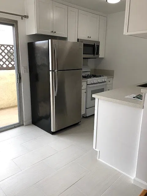 Kitchen with shaker cabinets and quartz countertops.