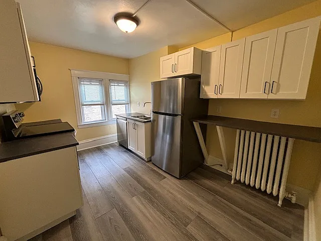 Kitchen, dishwasher, sink, refrigrator, cupboards, and counter.