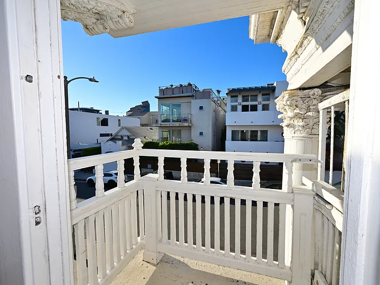 private balcony with ocean views overlooking multi-million dollars homes