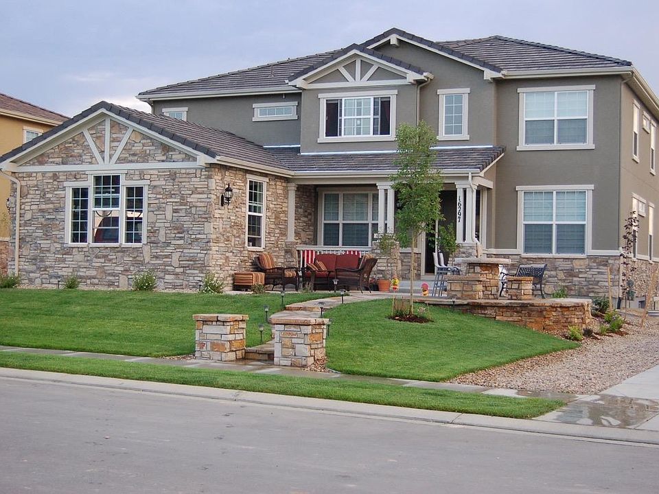 Front of home with stone walkway and built in stone table an