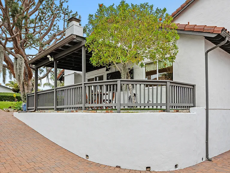 Exterior back / side with patio. Right most window is the kichen sink window.
