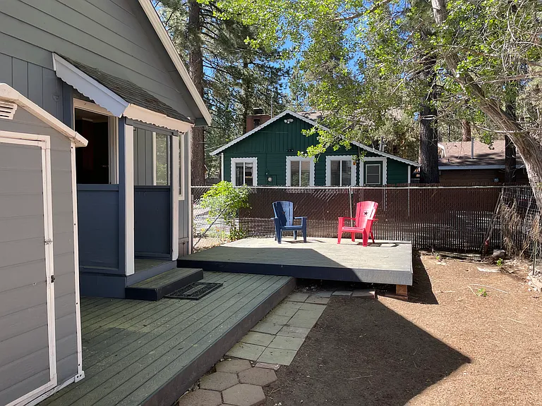 backyard and deck with small outdoor storage unit