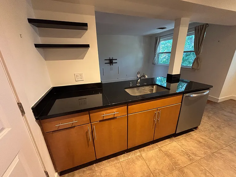 Granite countertops, large sink, and dishwasher.