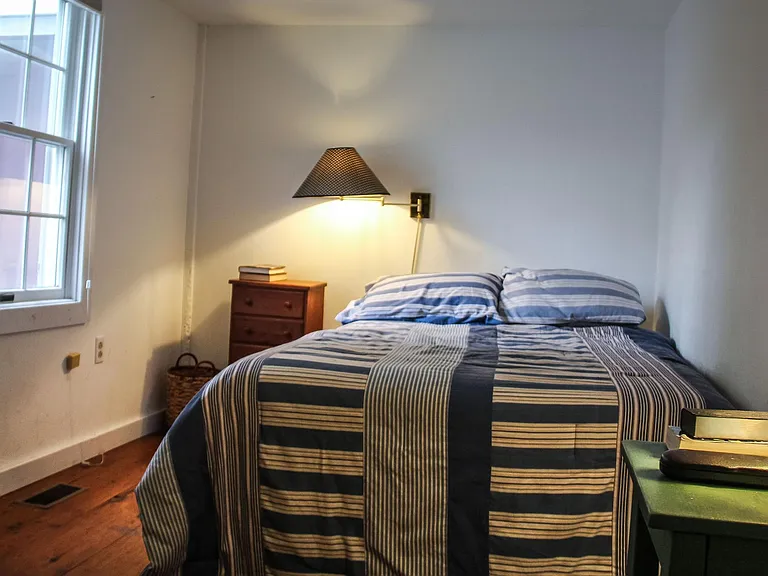 One downstairs bedroom is across from newly-renovated bathroom with walk-in shower and view to the back yard.