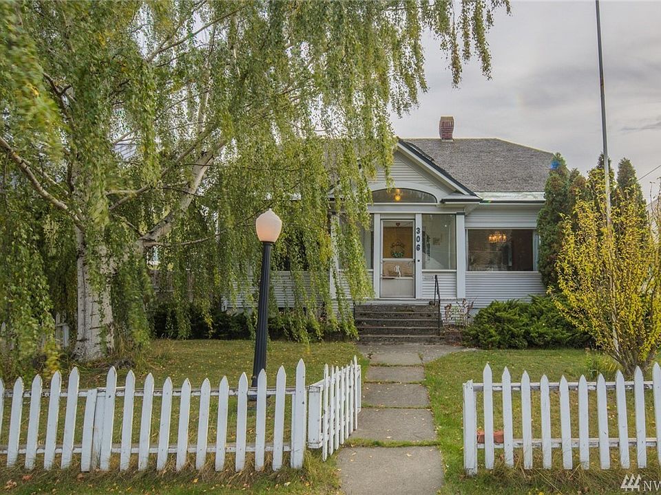 Beautiful white birch tree adds to the curb appeal along with the light post and white picket fence!