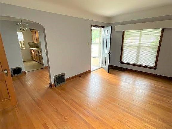 Living room with view into kitchenet and kitchen.