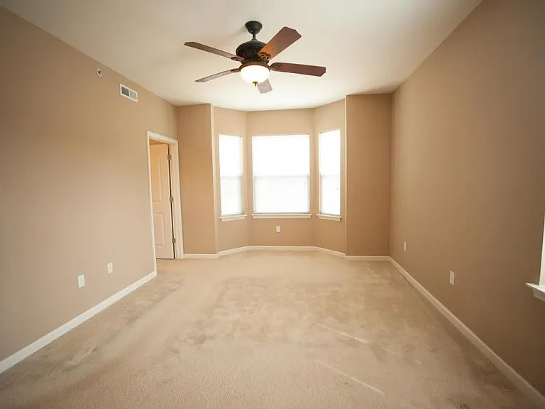Master bedroom with bay windows.