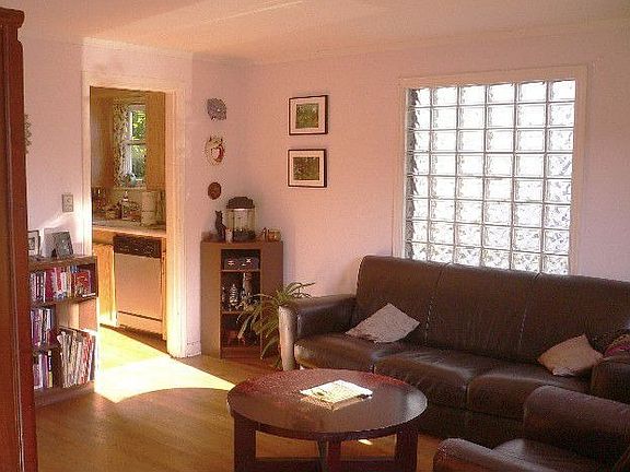 The living room is flooded with natural light. Hardwood floors are through-out. There are built-in s