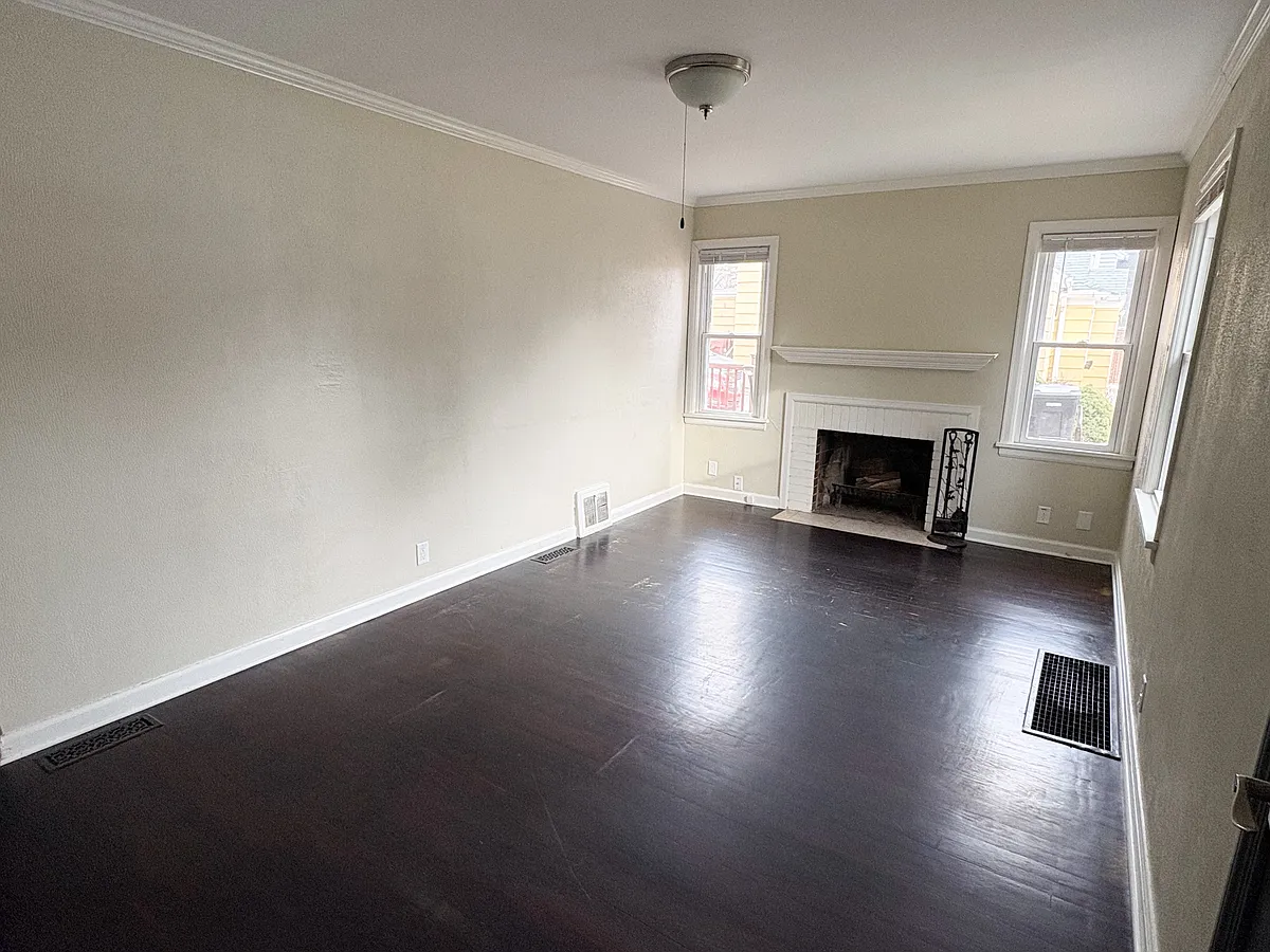 Living room with wood burning fireplace. - 1719 W Hamilton St