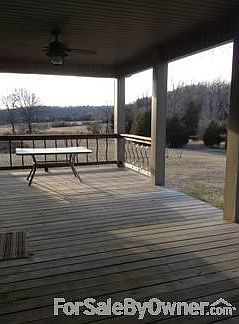 Back deck
						:
						adjoins an open patio area. Overlooks large pond seen in additional photo