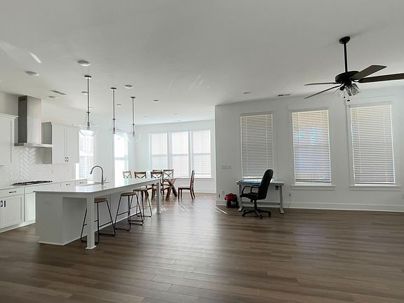 Open layout on first floor: kitchen, living room, and breakfast nook
