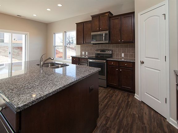 Kitchen opens to sun-filled breakfast nook.