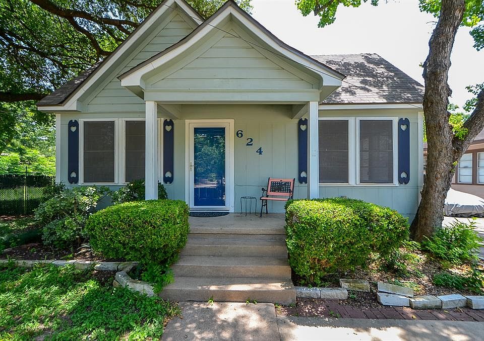 Charming one story home surrounded by luscious greens and mature trees