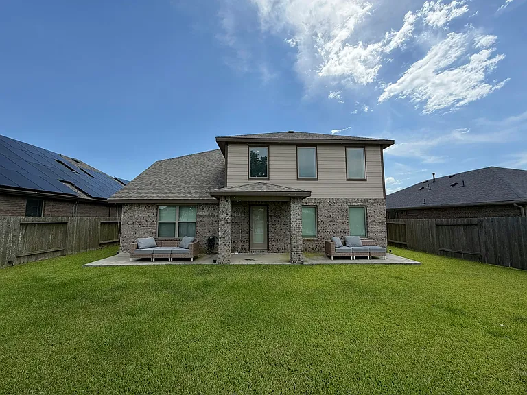 Spacious back yard with plenty of seating for large gatherings