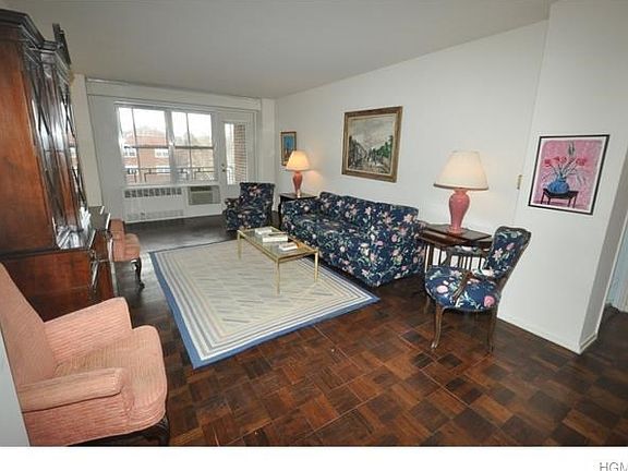 Large sunny living room opens to the "L" shaped dining room. There is a door that leads to a private