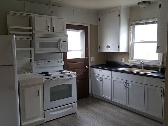 Kitchen includes refrigerator, stove, microwave
