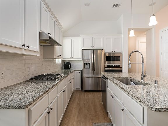 Open kitchen with large island. Refrigerator not included.