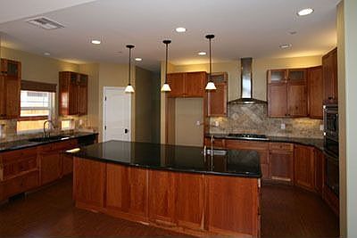 Abundance of cherry wood cabinetry compliments the stainless steel appliances