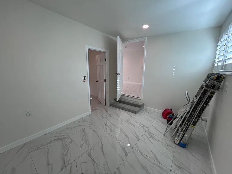 View from Wash Room: Bedroom 4 (left), and steps to Kitchen area (right)