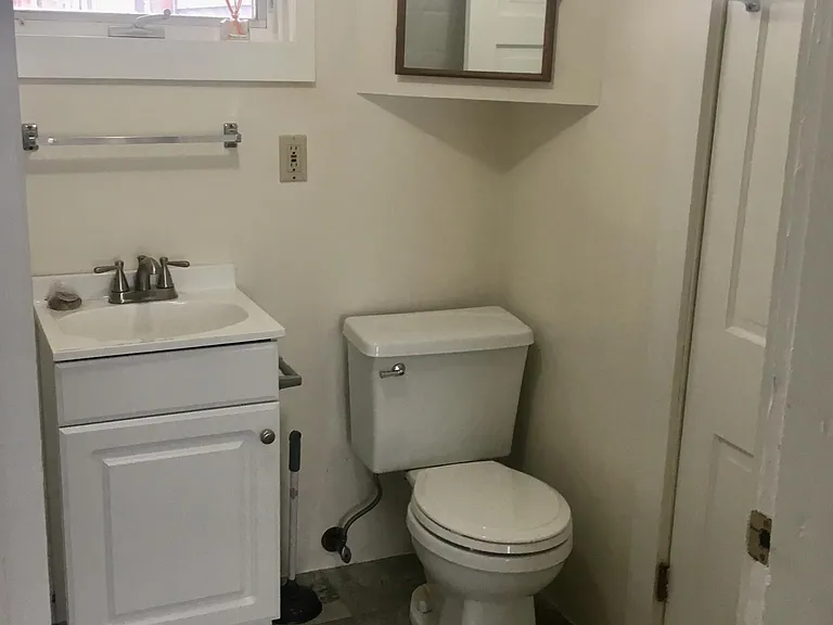 Full bath; tub/shower to the left, doorway to the living space to the right.