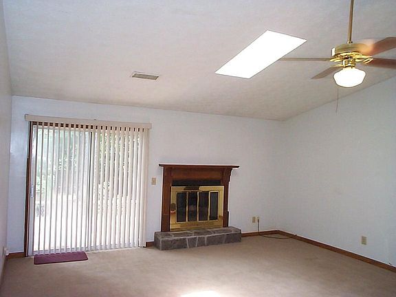 Big vaulted family rm has a fireplace and a sky light.