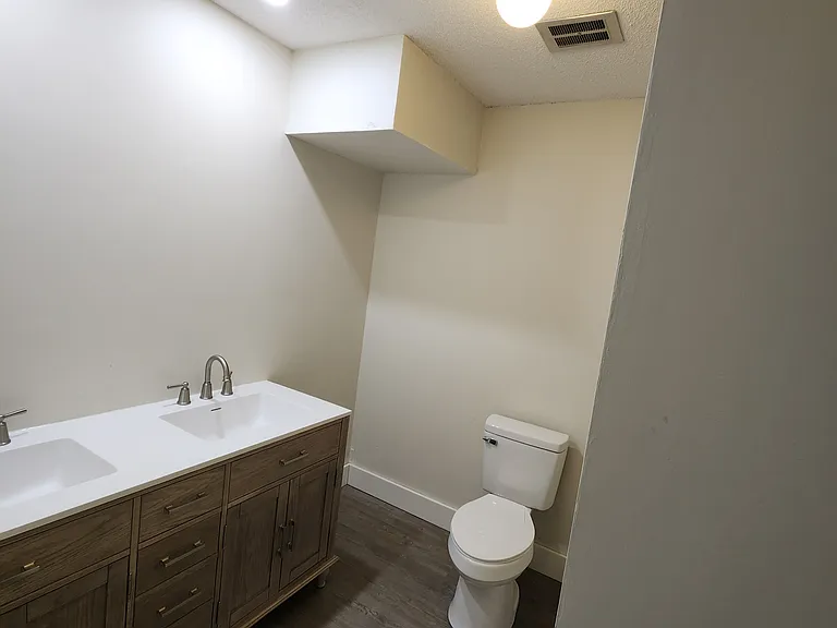 2nd level bathroom- brand new vanity, brand new sinks, brand new toilet and lights, bath tub on the right side (not visible in this picture)