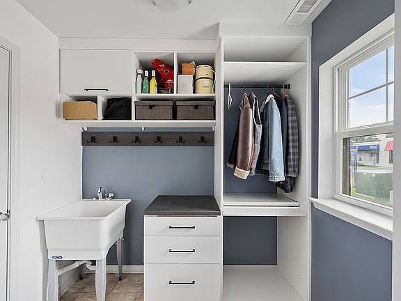 Mudroom with custom California Closets storage