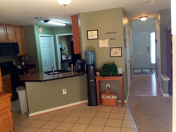 dining room w/ kitchen and hallway in background