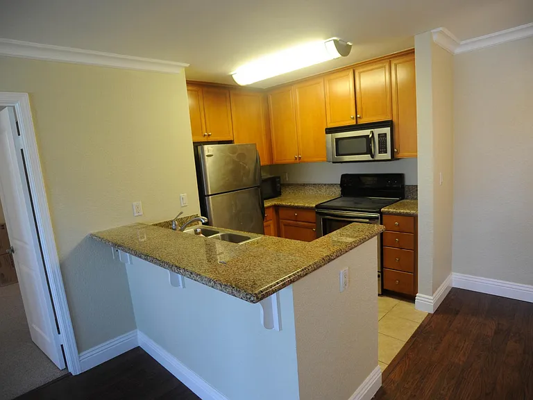 Kitchen with granite counter top and stainless steel appliances
