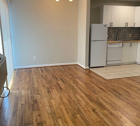 Breakfast area featuring new light fixture and recent refinished hardwood floors.