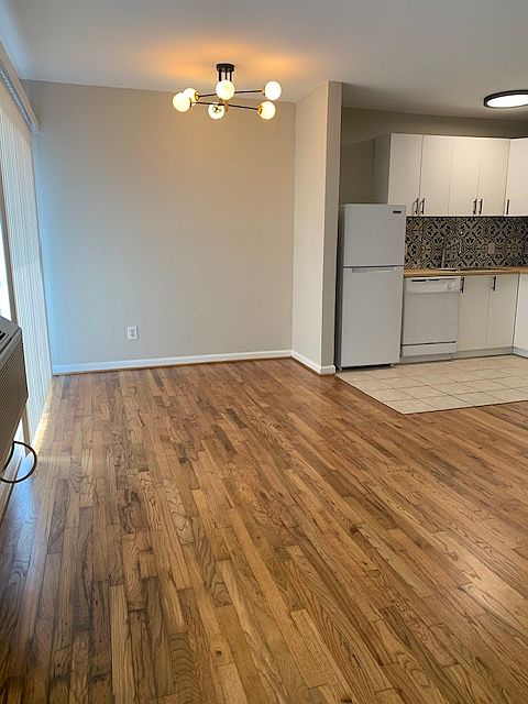 Breakfast area featuring new light fixture and recent refinished hardwood floors.