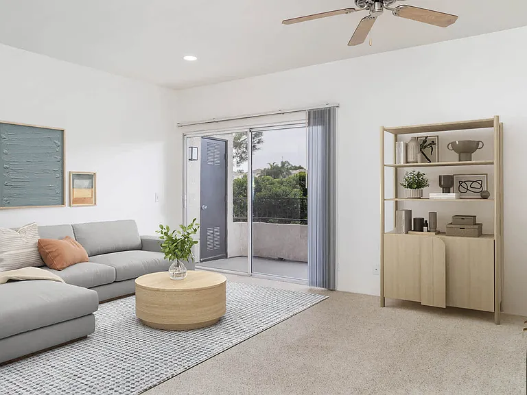 Carpeted Living Room with Balcony