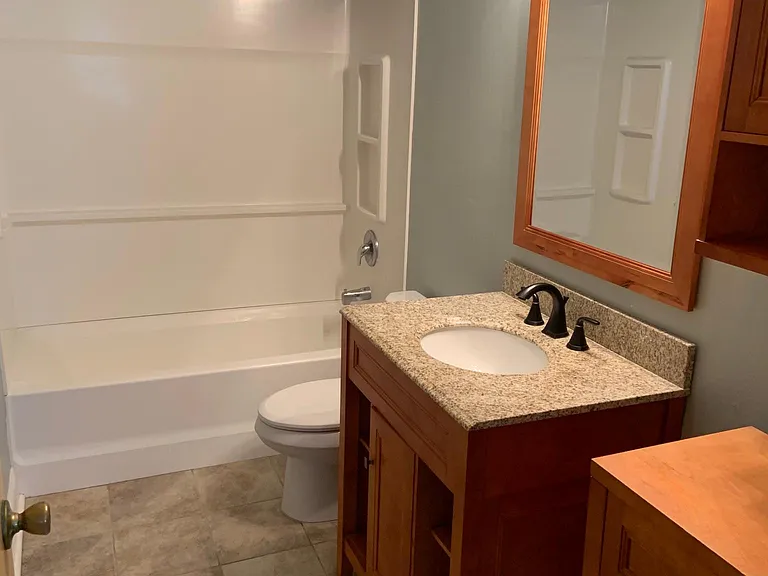 Updated master bathroom accessible through the master bedroom.