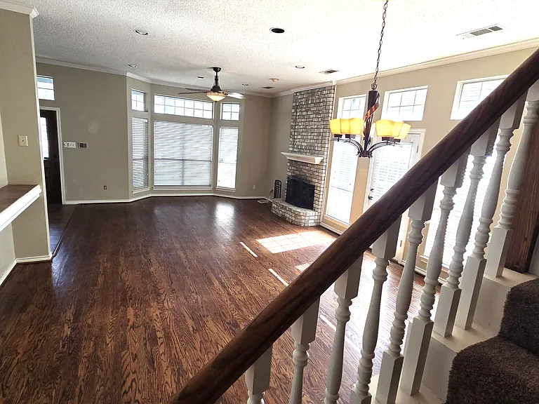 Spacious living room with genuine wood floors, ceiling fan, gas fireplace, tons of natural light and high ceilings. All LED lighting. Wonderful home to destress and relax after work.